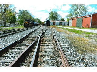 <b>TRACT #1 - GRAIN ELEVATOR</b>  (<b>SOLD - 9/9/16 $110,000</b>)
Note:  The grain bins, drier and legs are on R.R. leased property.  Mr. Voreis stated that lease payment is $900/year.

<b>Improvements - Grain Bins, Drier & Legs:</b>
1994     90,000 bu. bin with air tubes
1994     15,000 bu. hopper bin
               7,000 bu. bin
             42,000 bu. bin with air tube
<b>Drier:</b>  12'x45';1994 Zimmerman grain drier; S.S. 1,500 bu./hr. at 10 pts.;Natural gas
<b>Leg:</b>  1994 110' grain leg; 8,000 bu./hr.
<b>Drier Grain Leg:</b>  5,000 bu./hr.
<b>North Leg:</b>  7,000 bu./hr.
<b>Top Conveyor:</b>  1994 Chain Conveyor
<b>Bottom Conveyor:</b>  U-Trough Auger
<b>Dump Pit:</b>  Approx. 150 bu. with auger to leg

<b>Office:  Portable</b>  A 10' x 50' office with 2 separate offices, customer counter area, 1 restroom

<b>Grain Probe:</b>  A Hyd. Grain Probe

<b>Scales:</b>  10' x 60' Metal deck, scales, load cells, 100,000 lb. capacity, digital read-out and printer

<b>Quonset:</b>  A 41' x 120' metal Quonset building with concrete floor, top auger with 70,000 bu. capacity.

<b>Shop:</b>  A 22' x 40' wood frame with metal siding, concrete floor, heater

<b>Rail Siding:</b>  7+ Car rail siding along the east side of the grain bins.

<b>Utilities:</b>  City - Water and sewer; Electric - 480 (4) phase; Gas - Nipsco 

<FONT FACE="Arial, Helvetica, sans-serif" size="2" color="#0000FF"><b>TRACT #2 - STORAGE WAREHOUSE</b> (<b>STILL AVAILABLE</b>)

<b>2 Lots, Improvements</b>  60' x 112' wood frame structure, concrete floors, 4 doors, dock high load-out.</font face>



 - Grain Elevator (SOLD - 9/9/16) Storage Warehouse Still Available